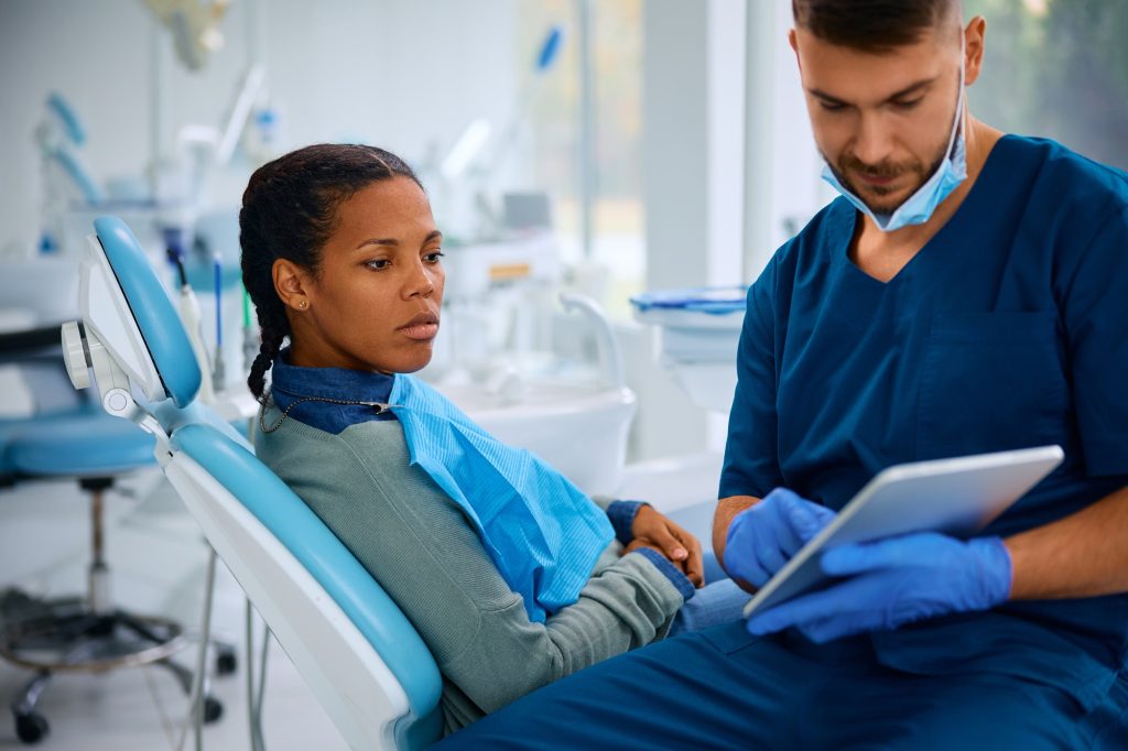 Concerned patient speaking with dentist during emergency dental consultation