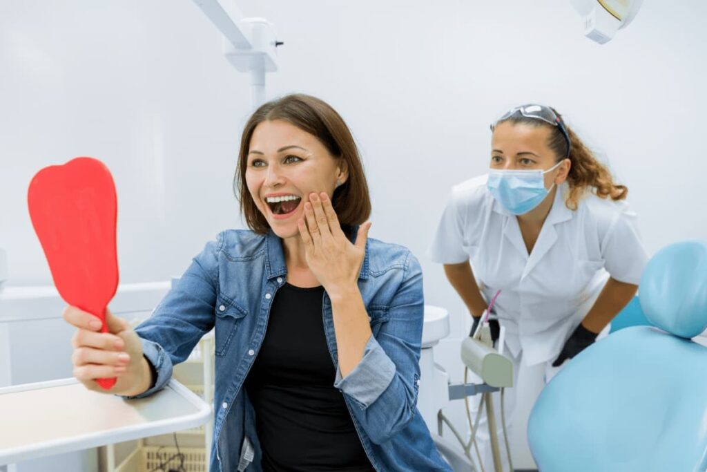 After receiving dental cavity fillings, a happy patient is thrilled at the results.
